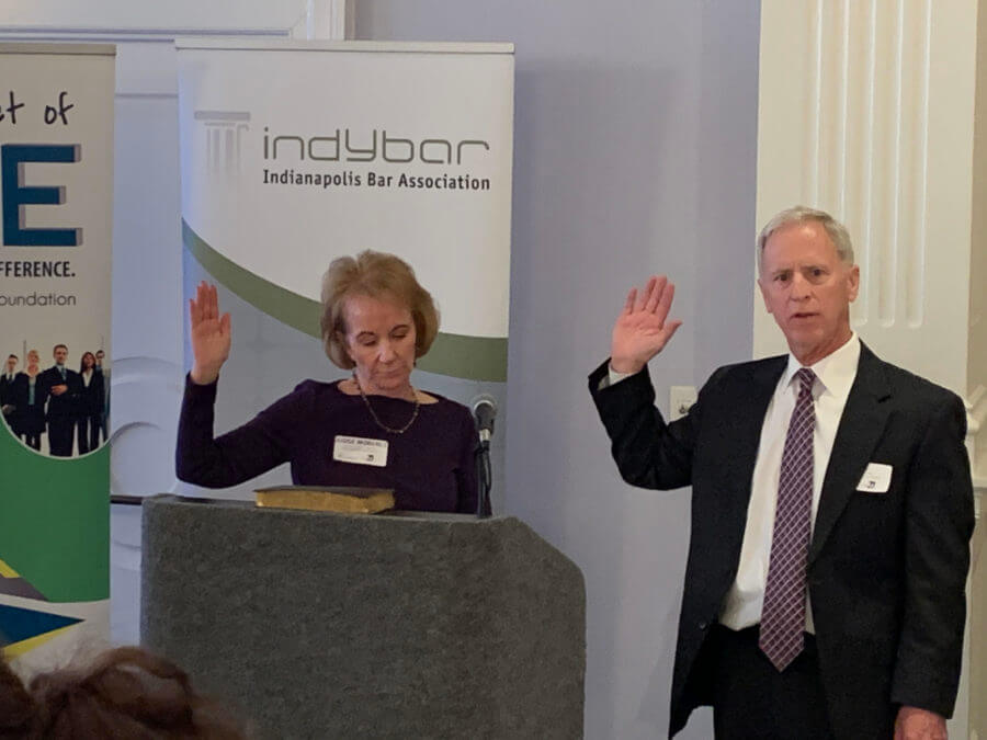 Two people with raised right hand