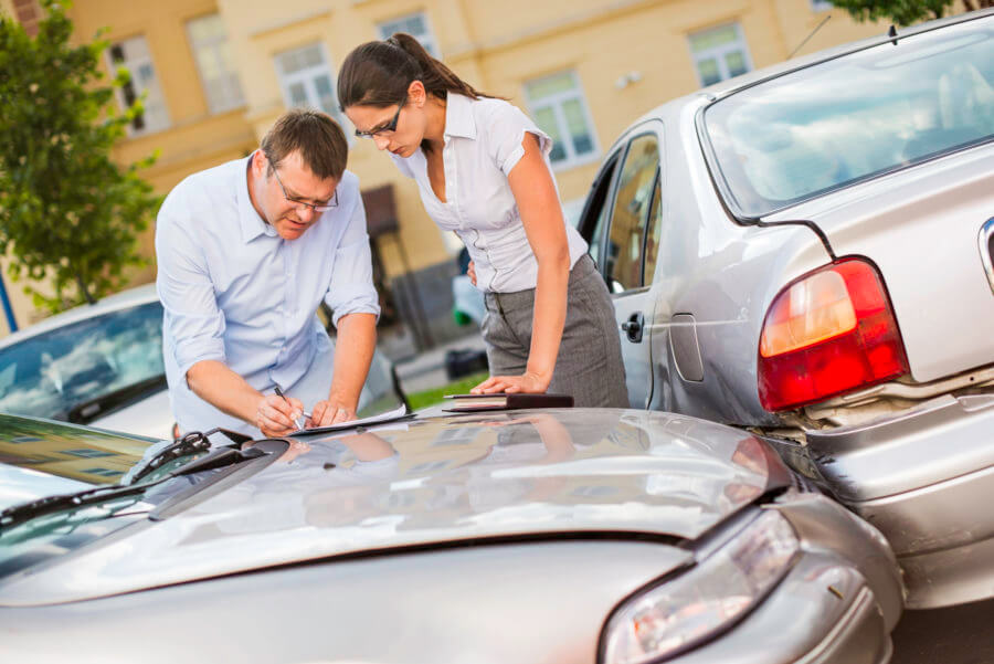 Two people exchanging information after a car accident