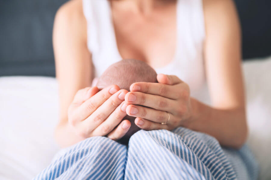Hands holding a baby